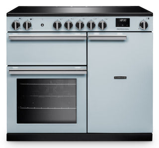 A classic-style dual oven range cooker in a light blue/slate color with a black glass cooktop and black base, featuring multiple control knobs and a digital display.