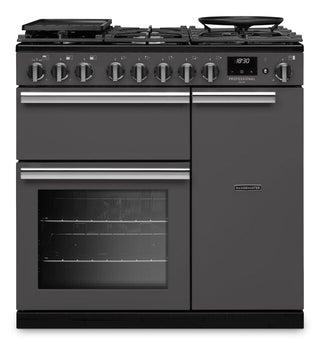 A dark gray freestanding gas range with a black enamel finish, featuring six front control knobs, a digital display, a lower oven with a glass door, and a right-side storage cabinet.