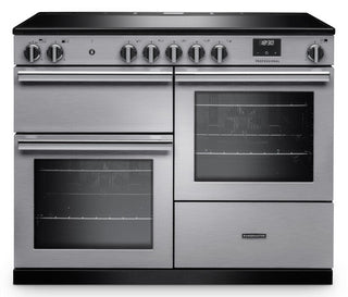 A stainless steel freestanding range cooker with a black glass cooktop, multiple control knobs, two oven compartments, and a lower drawer, shown on a plain white background.