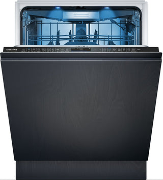 A Siemens built-in dishwasher in a dark charcoal woodgrain finish, shown with the door open to reveal the illuminated interior and upper rack.